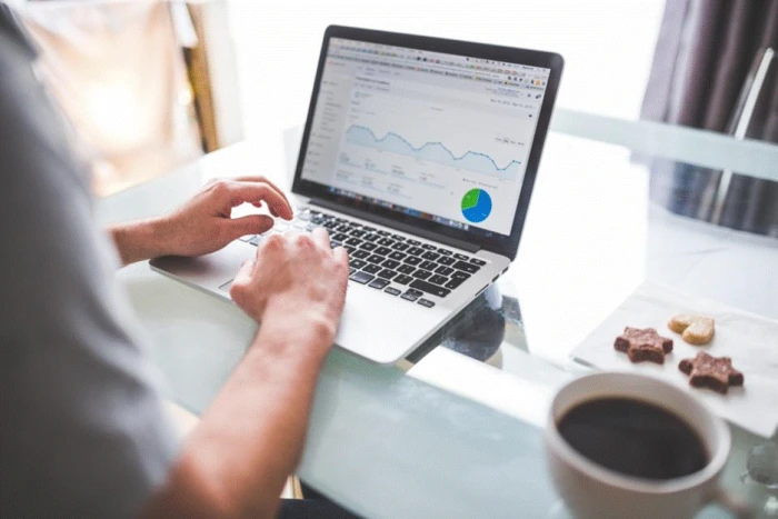 Title: Fig 2 - Description: Marketer reviewing a website analytics dashboard on a laptop