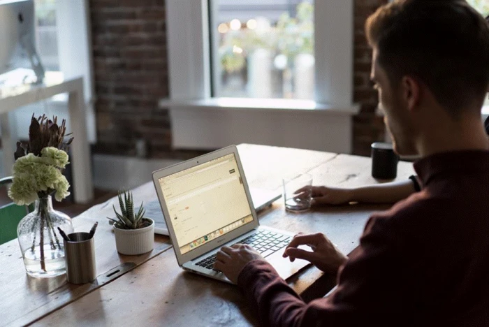 Title: Fig 4 - Description: Person working through a list of website pages on a laptop